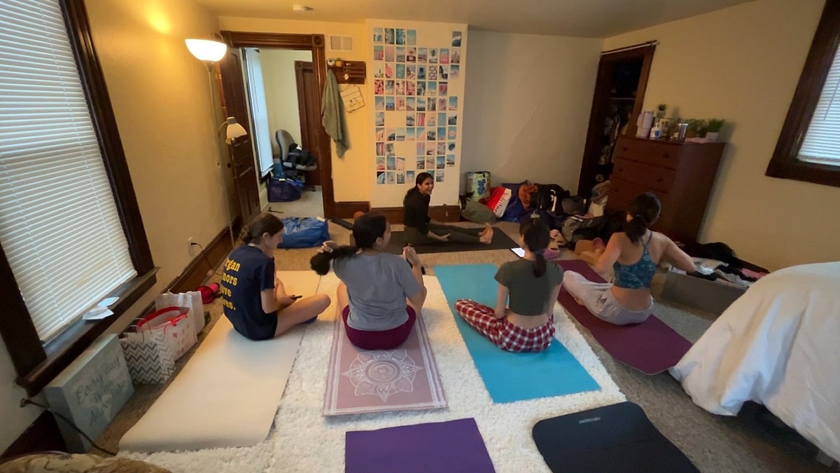 A cozy class on mats spread across a living room floor